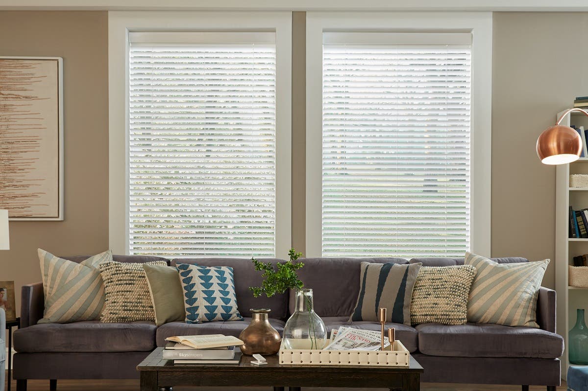 Living room with electric white wood blinds fully down